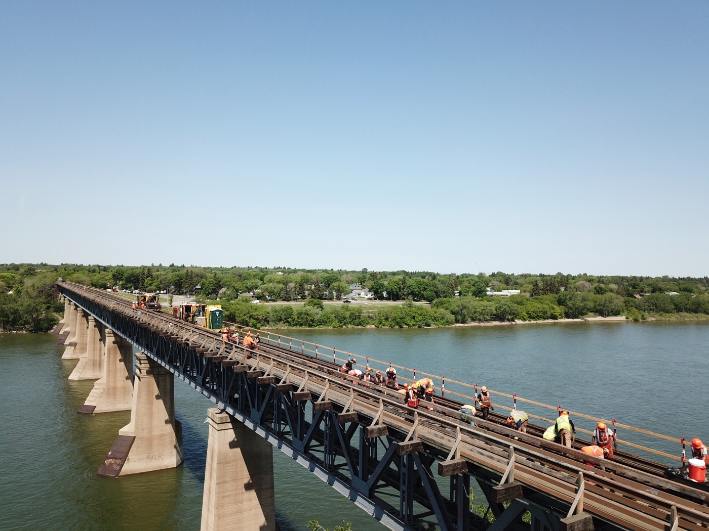 Crew renewing rail on the bridge deck